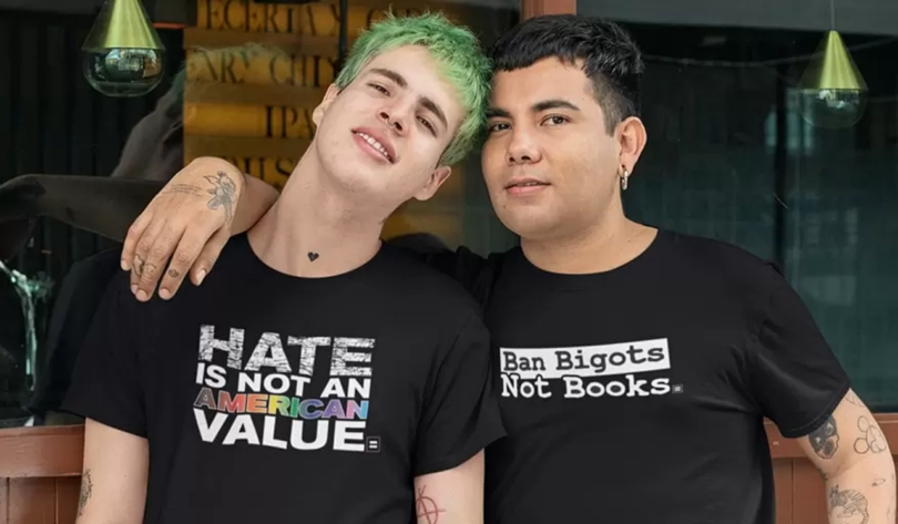 two people wearing black anti-hate t-shirts