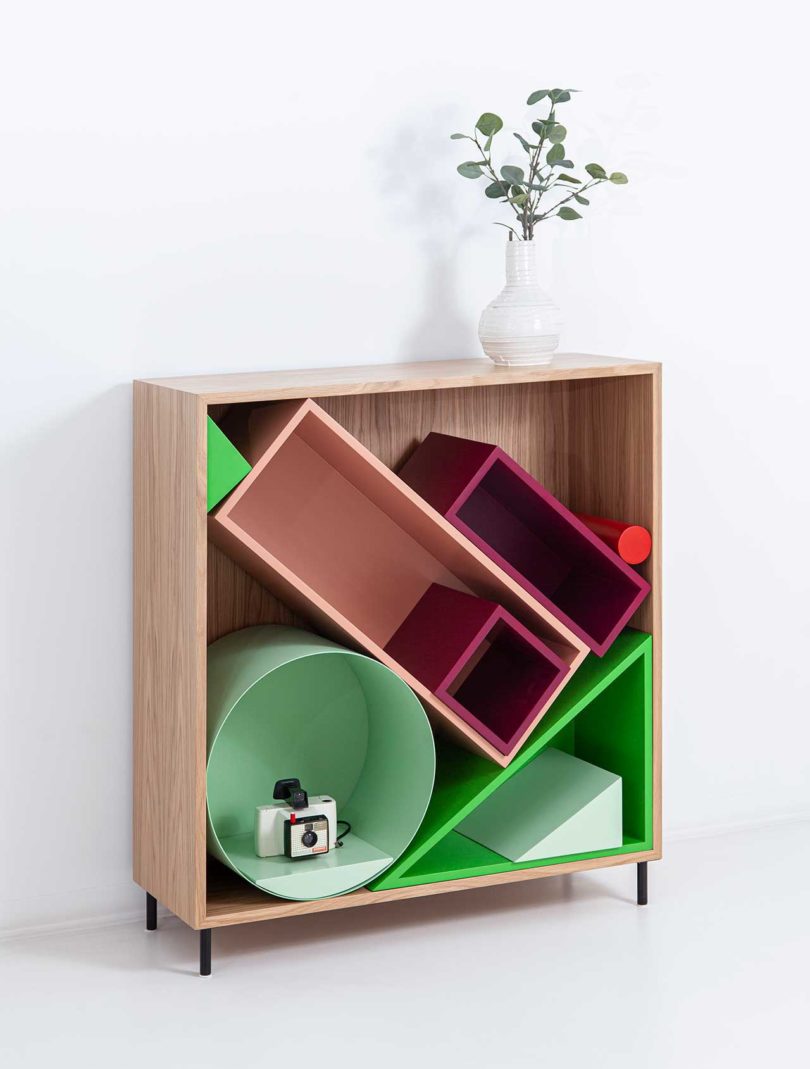 angled view of modular storage shelf with colorful geometric boxes inside