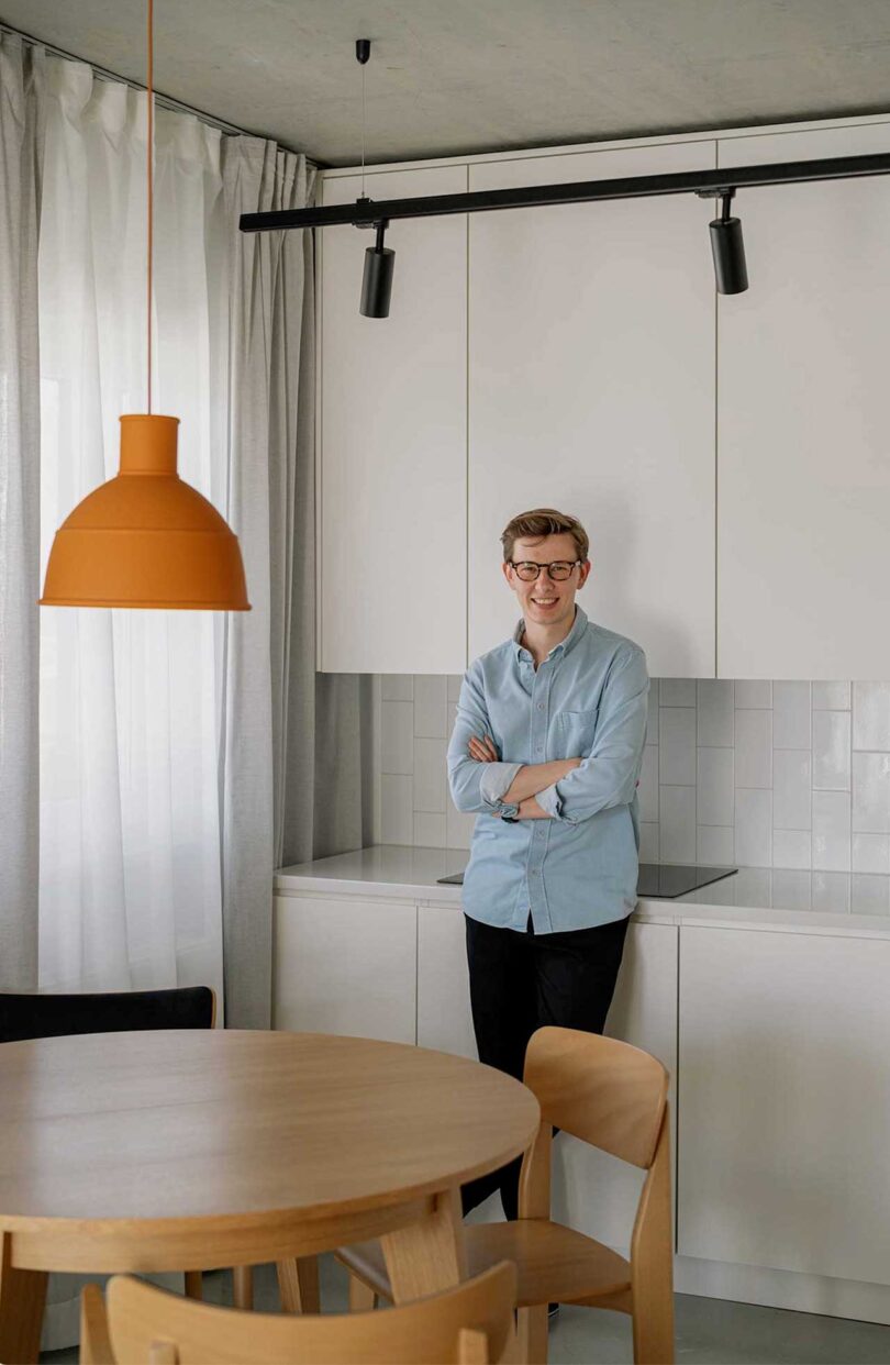 angled view of man standing in modern minimalist kitchen