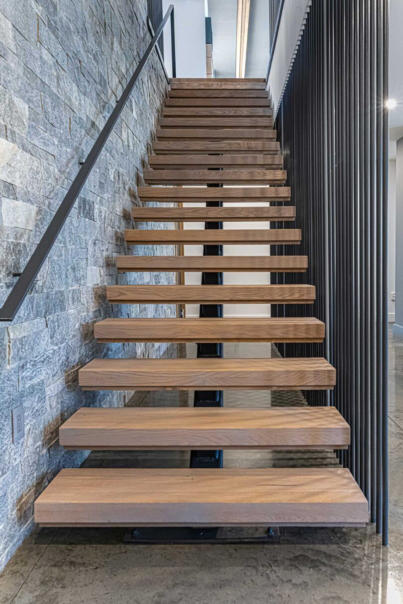 interior view of modern staircase looking up open wood treads