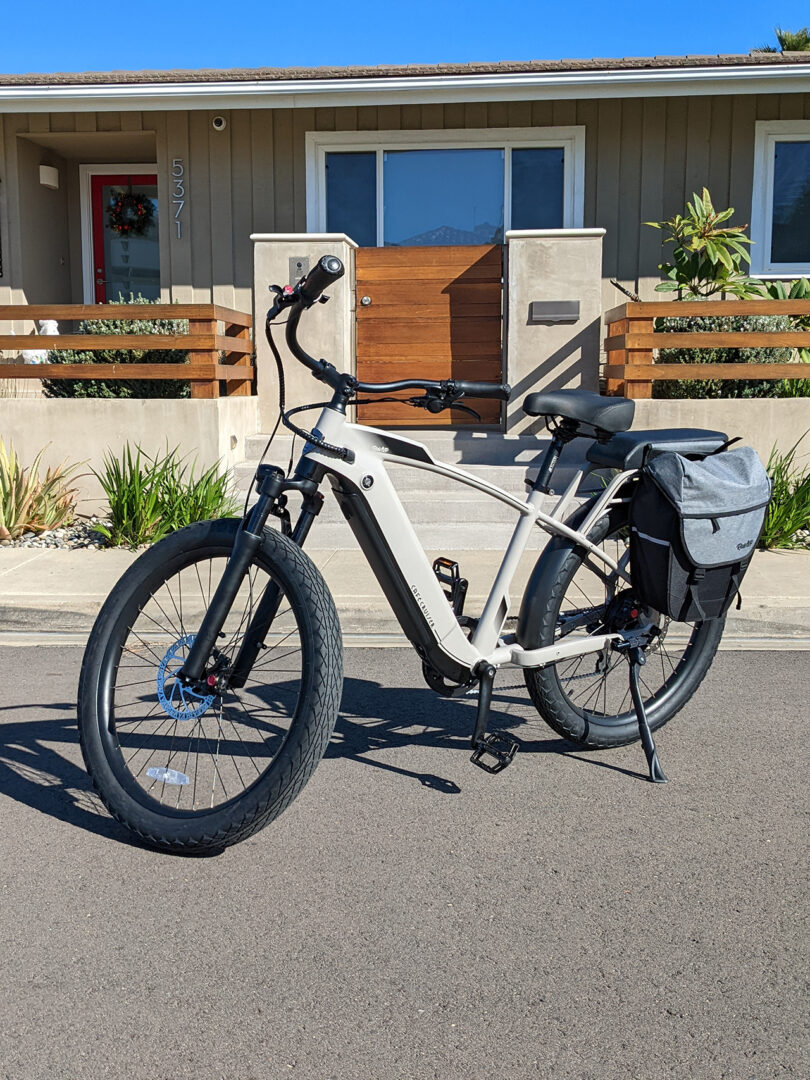cream colored e-bike parked in front of a modern home