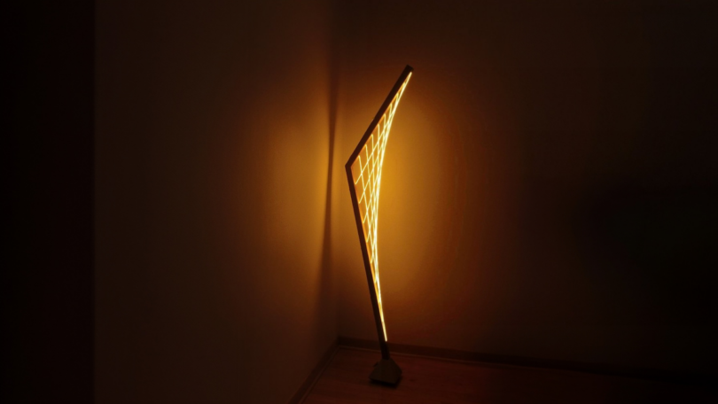 modern floor lamp glowing in the corner of a room