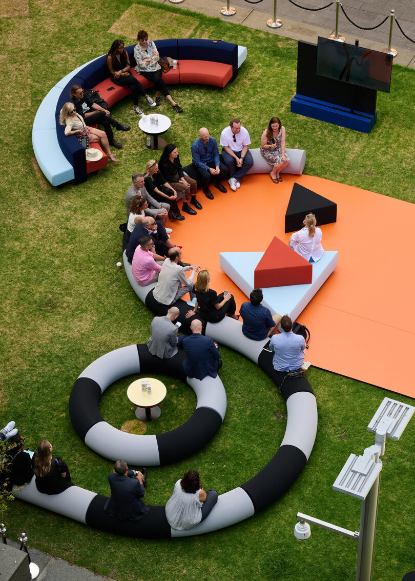 Outdoor lounge area with oversized, circular, black and white sofas