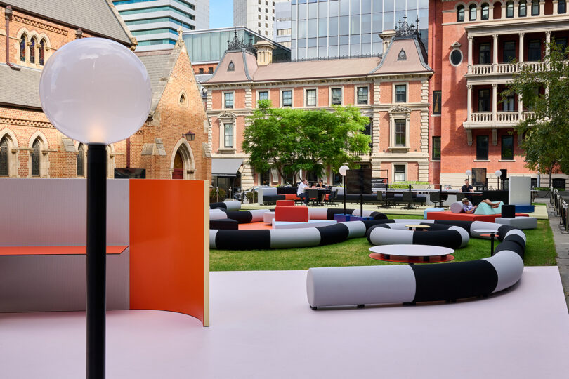 Outdoor lounge area with oversized, circular, black and white sofas